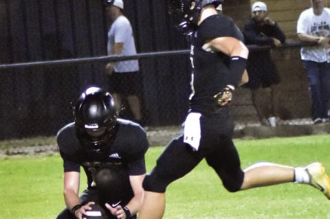 Brayden Holloway kicks the extra point for the Mustangs.