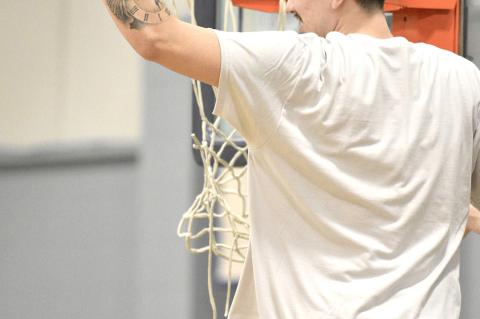 Chad Milne cutting down the net after winning the Regional Championship.
