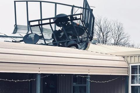 A riding mower and trailer landed on the carport roof at the Stephens home in Black Addition