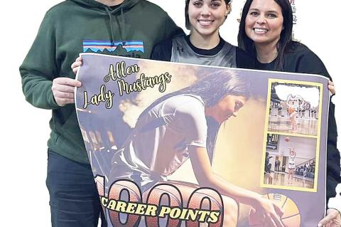Congratulations to Junior Cherish Woodward for scoring her 1,000 point last week. She is pictured with her parents Calem and Latisha Woodward.