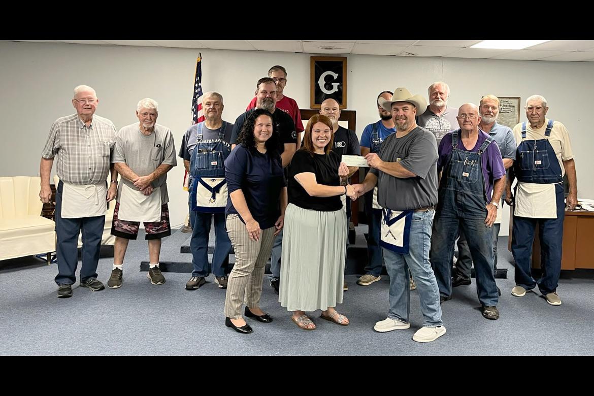 The Allen Masonic Lodge donated the proceeds of their fund raiser for Hailey Ellis recently. Ms. Elllis was the victim of a house fire that totaled her home and possessions. l-r Charles Speir, Bob Biggs, Ron Britt, Fred Price, Eric Martin, Ron Anderson, D