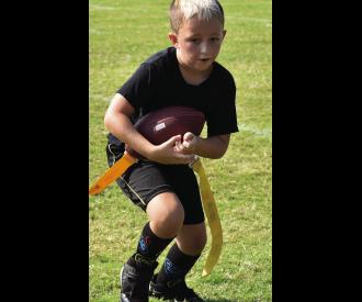 Colt Cross has a good run during last Saturdays Flag Football game. If you get a chance head the field on Saturdays to watch the fun.